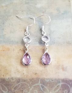 New Handmade Light Purple Amethyst Teardrop Dangle Earrings ~ Sterling silver earrings ~ Drop length 1.5 inches ~ Silver teardrop simulated light purple Amethyst charms ~ Round clear crystal charms ~ Sterling silver ear hooks ~ Hypoallergenic ☆I ship daily Monday-Saturday☆ Hell Lila, Purple Amethyst Earrings, Drop Earrings Silver, Tear Drop Earrings, Teardrop Dangle Earrings, Silver Lights, Silver Dangle Earrings, Crystal Charm, Amethyst Earrings