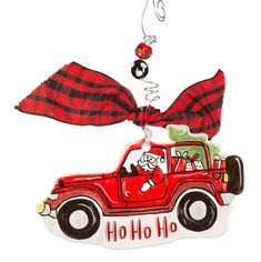 a christmas ornament with a red truck on it and a bow hanging from the front