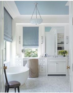 a bath room with a tub a sink and a window