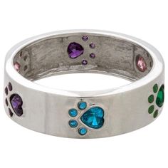 a silver ring with paw prints and colored stones