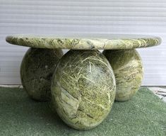 three stone balls sitting on top of each other