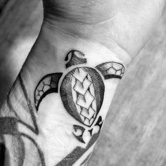 a black and white photo of a hand with a tattoo on it's wrist