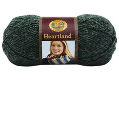 a ball of yarn that is green and has a brown label on the end of it