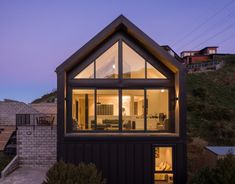 a small house sitting on top of a hill