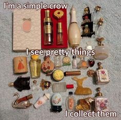 an assortment of perfumes and other items on a white towel with the words, i'm a simple crow i see pretty things i collect them