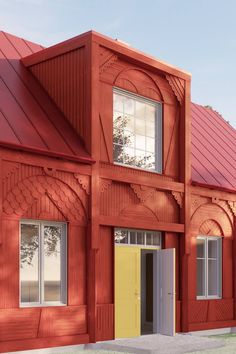 a red building with a yellow door and windows