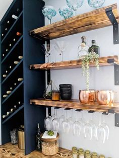 wine glasses and bottles are sitting on the shelves