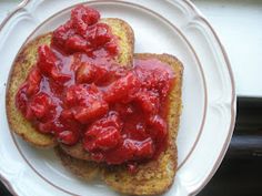 two pieces of toast with strawberry jam on them