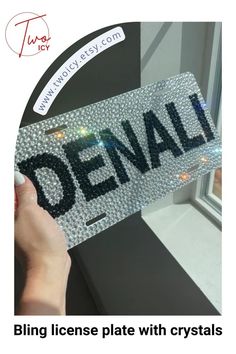 someone is holding up a license plate with crystals on it that says,'bling license plate with crystals '