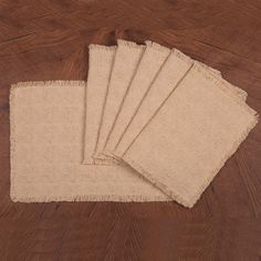 four pieces of burlock cloth on a wooden table