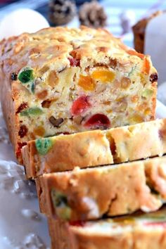 a loaf of fruity bread sitting on top of a white plate