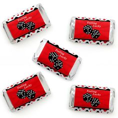 four red candy bars with black and white designs on them