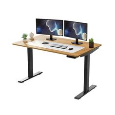 two computer monitors sitting on top of a wooden desk