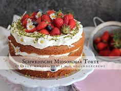 a cake with white frosting and strawberries on top