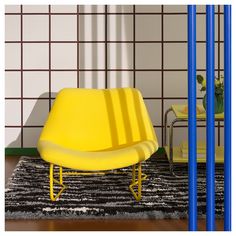 a yellow chair sitting on top of a black and white rug next to blue poles