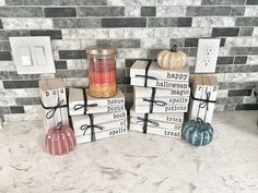 three wooden blocks decorated with black and white designs, one has a candle on top