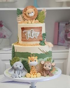 a three tiered cake decorated with animals and the word fluff on it's top