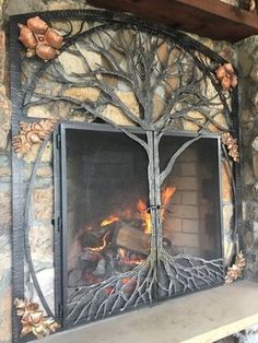 a fireplace with a tree on the mantle and fire burning in it's hearth