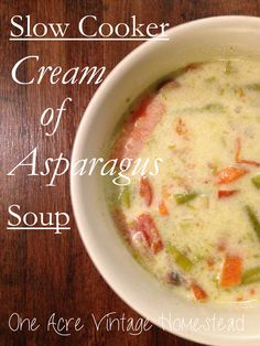 a white bowl filled with soup on top of a wooden table