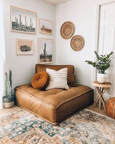 a living room filled with furniture and pictures on the wall