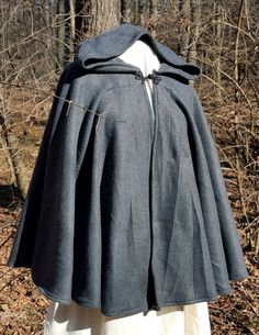 This short cloak is delightfully soft and comfortable. It's long enough to reach the back of the hand, keeping you warm but keeping your hands available when needed. It has a full hood and closes with a matching cloth frog clasp. This cloak is great for a costume piece or a cozy jacket, great for Spring, Fall, or over air conditioned buildings.Your cloak will measure about 30 inches in length. This listing is in dark grey, but other colors are available in my store or on request. The material is Hooded Wool Cape For Winter, Solid Hooded Cape For Fall, One Size Cape For Cold Weather, Hooded Fall Cape For Larp, Hooded Cape For Larp In Fall, One Size Hooded Cape For Fall, Medieval Style Winter Cape Outerwear, Medieval Winter Cape Outerwear, Cozy Hooded Cape For Fall