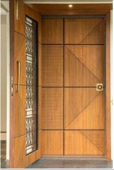 an open wooden door with decorative glass panels