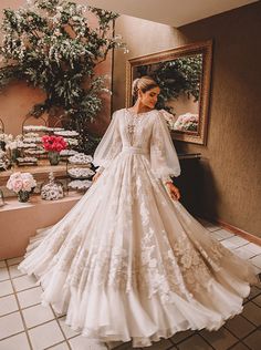 a woman in a wedding dress standing next to a mirror