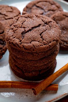 chocolate cookies and cinnamon sticks on a plate