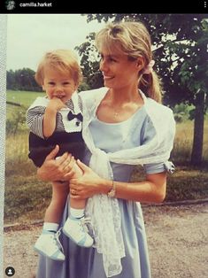 a woman holding a small child in her arms