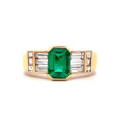 1.25 Carat Emerald Cut Emerald Engagement Ring in 18k This engagement ring features a captivating 1.25-carat emerald cut emerald as the centerpiece, set in a half bezel that showcases its vibrant green hue. Flanked by channel-set baguette diamonds, the ring boasts a total diamond weight of 1.06 carats, with each diamond measuring 1.75 x 4.50 mm, F color, and VS2 clarity. The addition of square emerald cut diamonds on either side of the baguettes adds a unique touch. Crafted in polished 18 karat Green Emerald-cut Diamond Ring Channel Set, Green Emerald Cut Diamond Ring Channel Set, Channel Set Emerald Cut Emerald Ring, Emerald Cut Emerald Ring Channel Set, Emerald Cut Channel Set Emerald Ring, Half Bezel, Platinum Rose Gold, Sapphire Solitaire, Baguette Diamonds