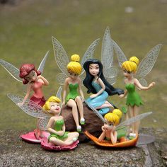 a group of fairy figurines sitting on top of a rock with the caption ebay $ 10 99