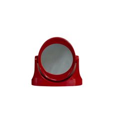 a red mirror sitting on top of a table