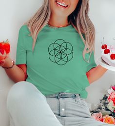 🌱 Do you love yoga, spirituality, and flower of life? If so, you'll love this Seed of Life Meditation Shirt. This unisex short sleeve tee features a beautiful design of a seed of life symbol. It's the perfect way to show off your love for yoga, spirituality, and flower of life. 👕 This t-shirt is made of high-quality cotton that is soft, comfortable, and durable. It has a unisex fit that suits any body type. You can choose from 2 different colors to suit your mood and style. The colors available are black and navy. The t-shirt is also easy to wash and dry, as you can machine wash it in cold water and tumble dry on low heat. 🎁 This t-shirt also makes a great gift for your friends and family who love yoga, spirituality, and flower of life. You can surprise them with this t-shirt on their b Seed Of Life Shirt, Yoga Spirituality, Yoga Spiritual, Seed Of Life, Positive Shirt, Life Symbol, Aesthetic Shirts, Yoga Shirts, Flower Of Life