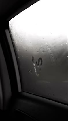 the rear view mirror of a car with rain drops on it