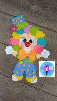 a paper cut out of a clown on a wooden floor