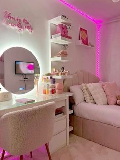 a bedroom with pink lighting and white furniture