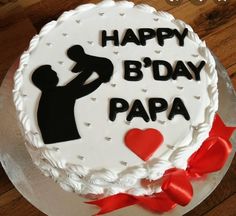 a birthday cake with the words happy b'day papa on it and a red bow