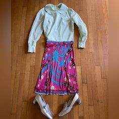 This is a beautiful 1960s Emilio Pucci stretch silk skirt.  It is pleated at the front and zips at the side. It has all of the iconic hallmarks of a vintage pucci skirt - vibrant colors - bright pinks, blues, whites.  It's banded at the waist and bottom, and has flowers throughout. It's also signed with Emilios signature throughout.  It's marked a vintage size 6 with measurements in photos - approximately an extra small. Overall in good vintage condition with a few small flaws - a few pinholes, Vintage Fitted Flared Pleated Skirt, Spring Vintage Fashion Fitted Skirt, Vintage Fitted Knee-length Pleated Skirt, Fitted Vintage Fashion Skirt For Spring, Fitted Skirt For Spring Vintage Fashion, Chic Fitted Silk Pleated Skirt, Fitted Silk Full Pleated Skirt, Vintage Fashion Full Skirt, Fitted Silk Pleated Skirt