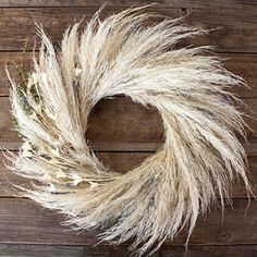 a dried wreath sitting on top of a wooden table