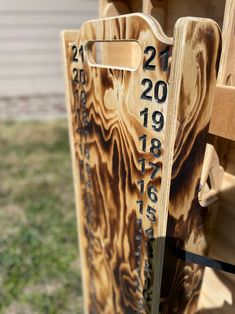 two wooden sleds with numbers on them sitting next to each other in the grass