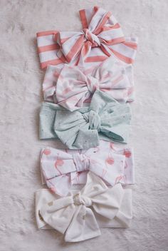 several bows are laid out on a white blanket