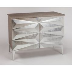 a mirrored cabinet with two doors and an abstract design on the front, one door open