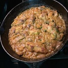 a skillet filled with food cooking on top of a stove burner in the oven