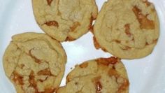 four cookies sitting on top of a white plate