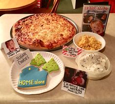 a table topped with pizza, cookies and other foods