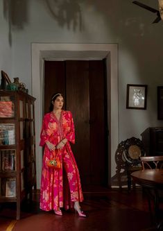 Floral jaal print kaftan set is crafted beautiful in hues of pink and oranges, featuring V-neck, patch border, drop sleeves, front slit and elastic gathers to accentuate the waist. The border is hand embroidered using mirror, resham, sequins, nakshi and cutdana. It is paired with straight cut printed pencil pants. Kaftan Set, Crafts Beautiful, Indian Outfit, Pencil Pants, Custom Tailoring, Indian Outfits, Asian Fashion, Straight Cut, Cotton Silk