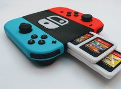 two nintendo wii game controllers sitting next to each other on top of a white table