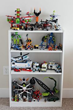 a white book shelf filled with lots of toys