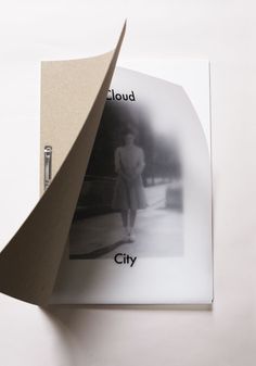 an open book with black and white photos on the cover, which reads cloud city