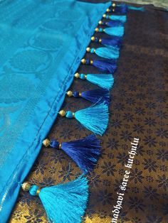 the tassels on this blue and gold sari are very decorative